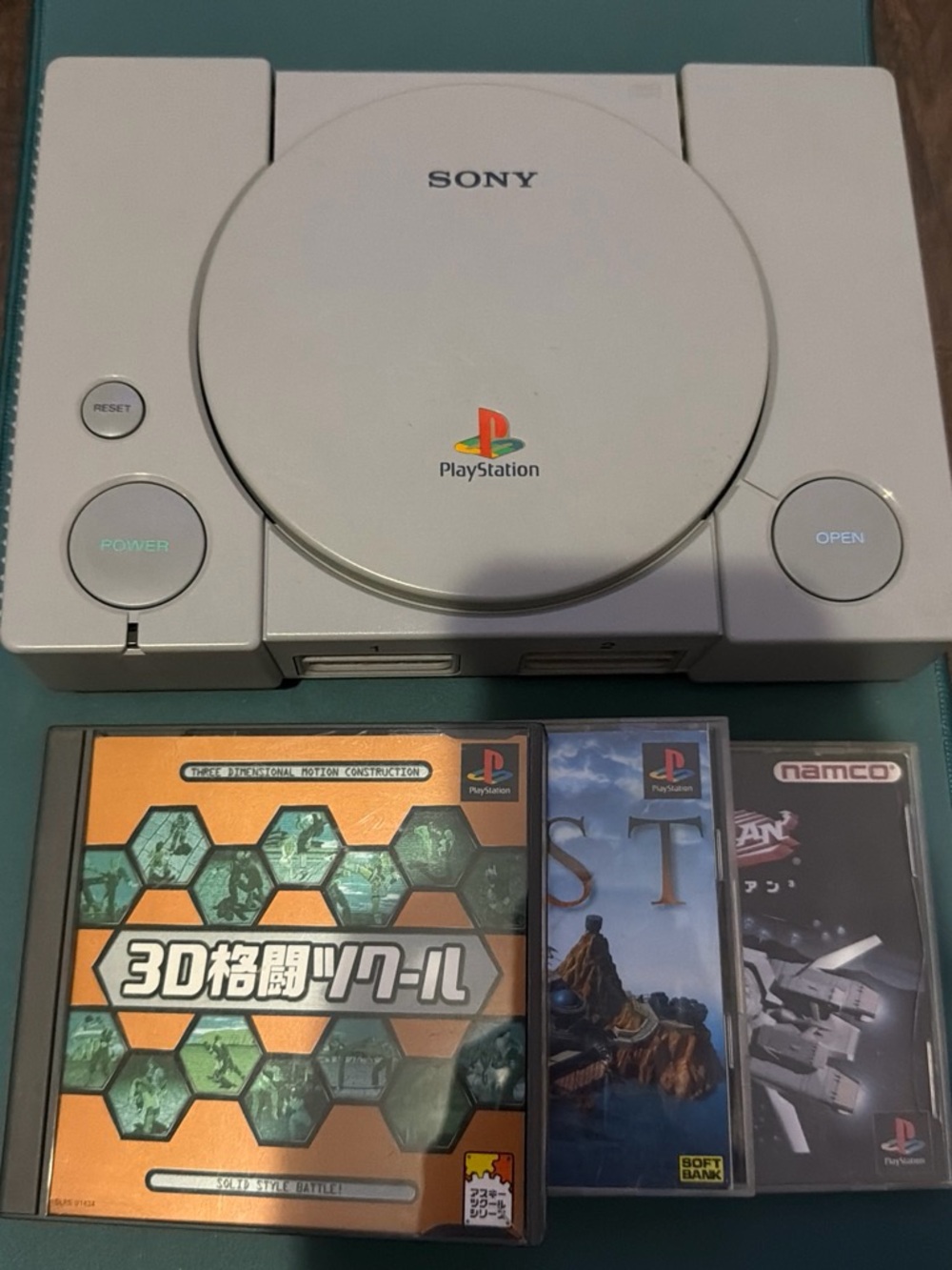 Sony PlayStation Console in Light Gray with 3 Game Discs